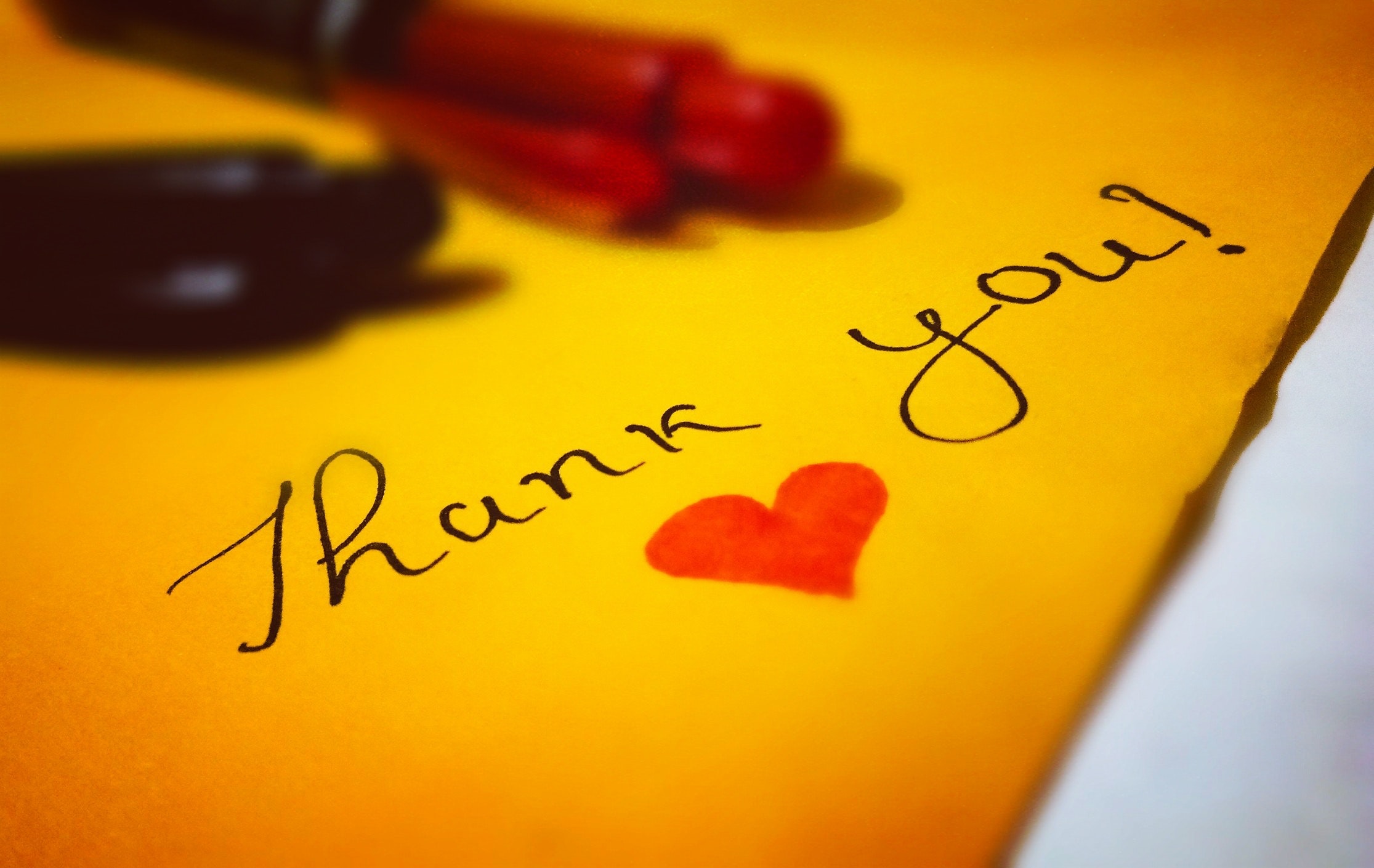 Yellow letter with thank you written on it